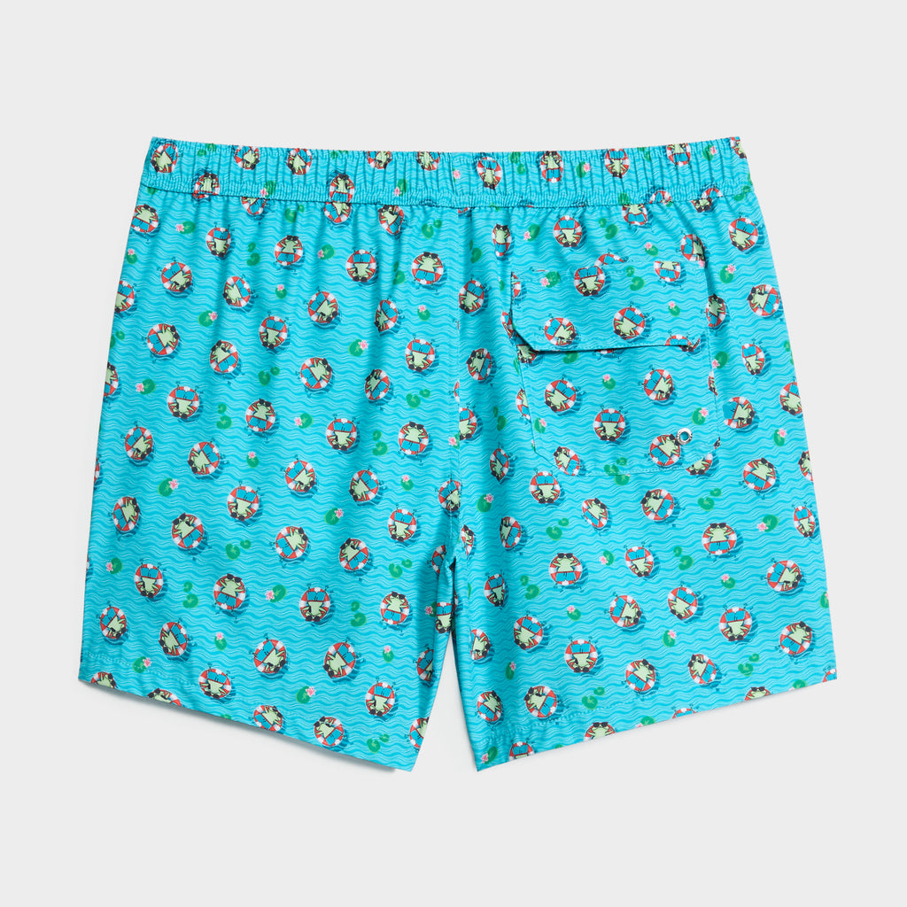 CROAK & FLOAT by PUBLIC BEACH SWIM: Bright blue men's swim shorts with elastic waistband, back pocket, and quick-dry fabric. Features a playful cartoon sailor-in-lifebuoy pattern floating on wavy water.