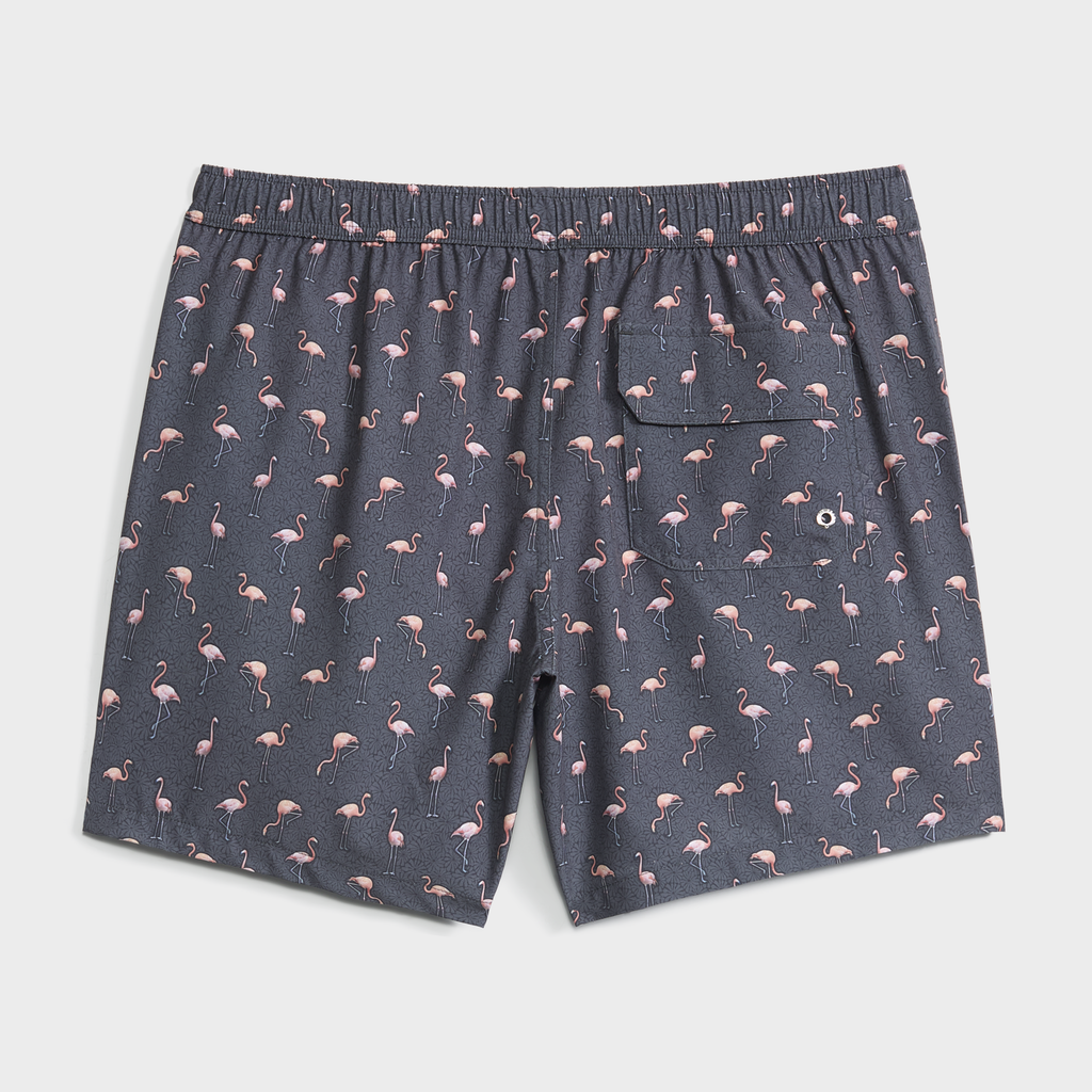 PUBLIC BEACH SWIM’s FLAMINGO VIBES swim trunk features a gray base with pink flamingo print, elastic waistband, and a back pocket with drainage—ideal quick-dry swimwear for your next beach adventure.