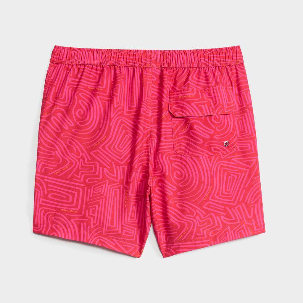 The TWISTED PATH swim shorts by PUBLIC BEACH SWIM feature a bright pink maze-inspired print, elastic waistband, quick-dry fabric, and a back pocket with drainage grommet. Shorts are laid flat on a white background.