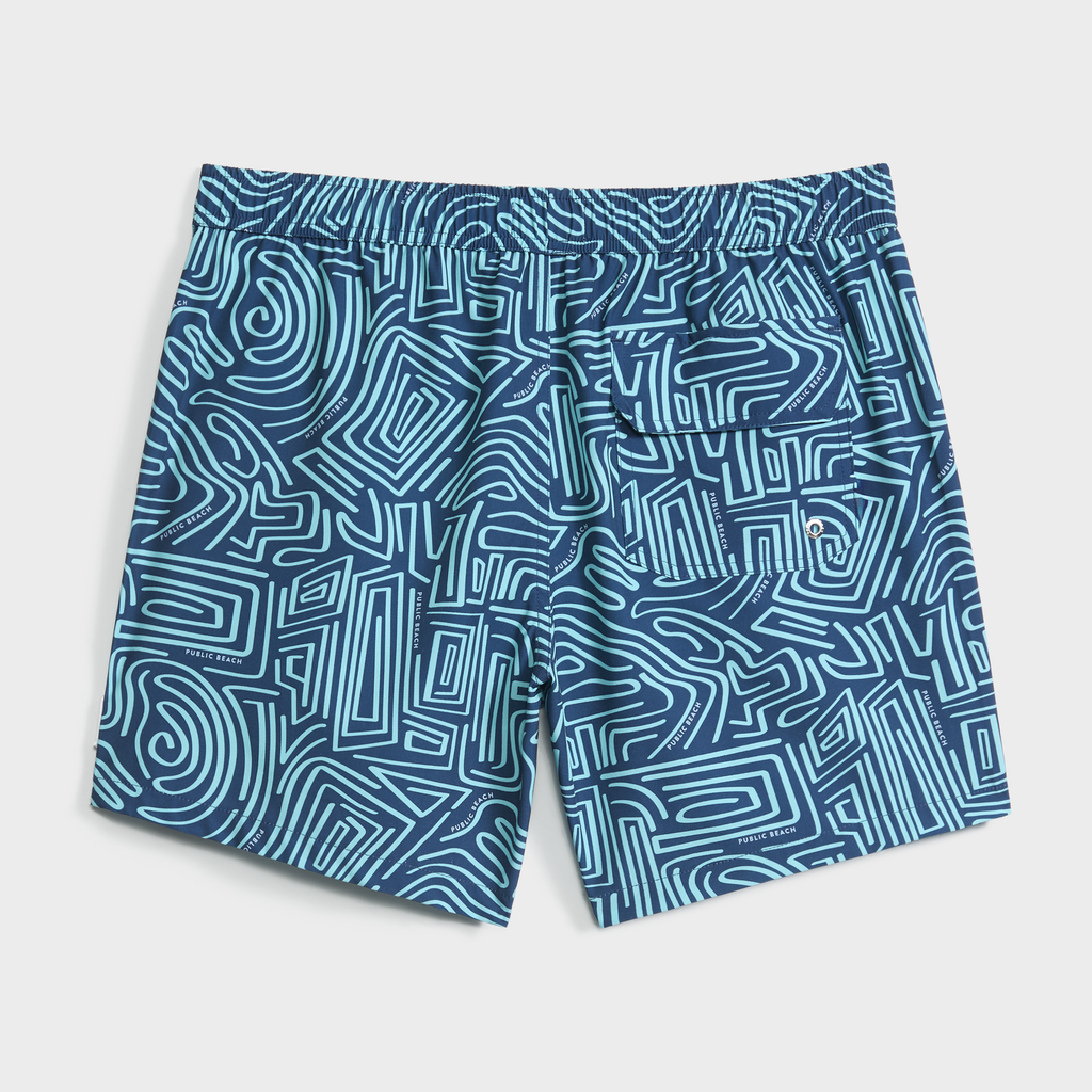 PUBLIC BEACH SWIM's TWISTED PATH swim shorts feature a teal and light blue abstract maze pattern, quick-dry fabric, elastic waistband, and right back pocket. Shown flat on a light background.