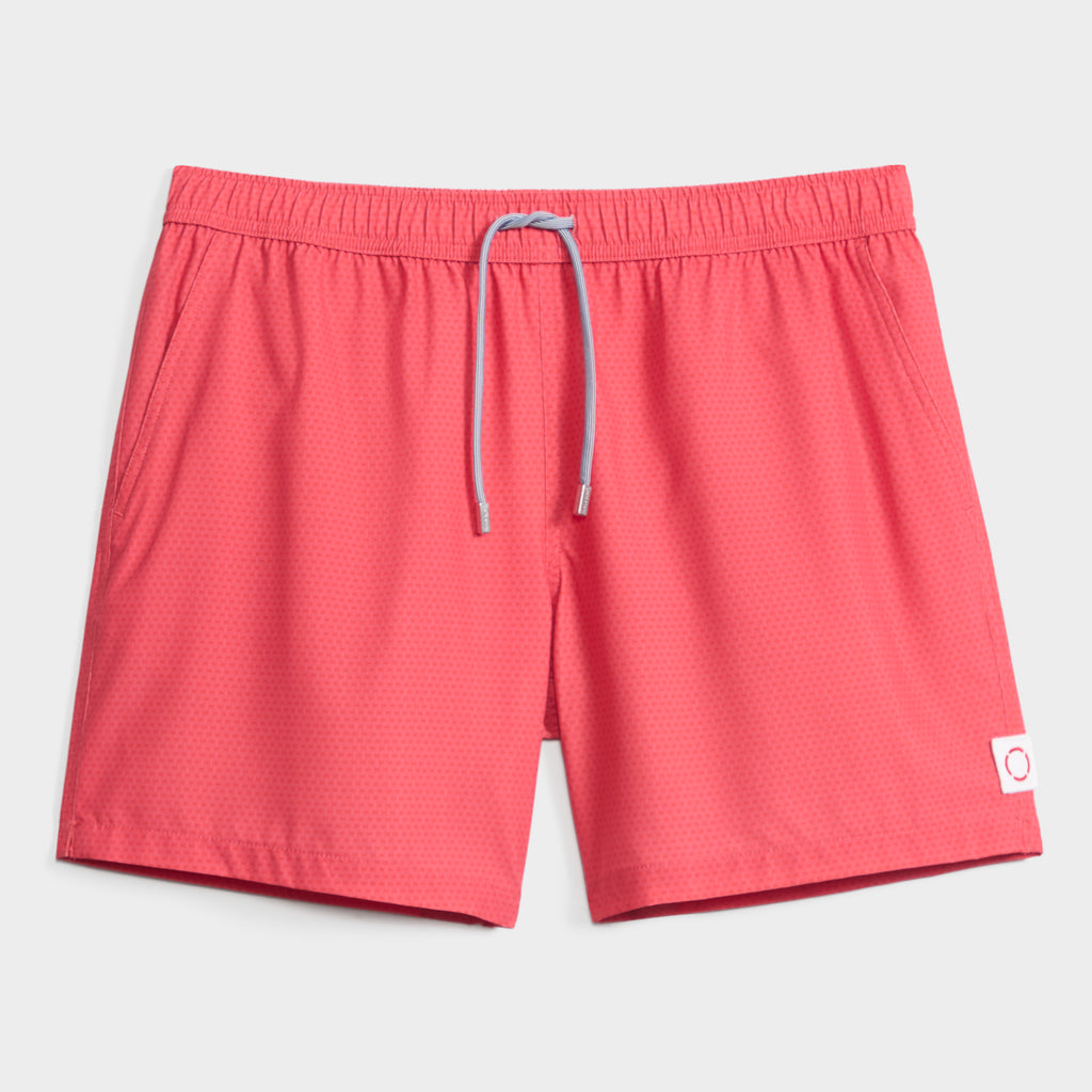 The LINK FLOW men’s swim short by PUBLIC BEACH SWIM features a subtle dotted red pattern, light blue drawstring, elastic waistband, and small white patch—quick-dry and perfect for beach days.